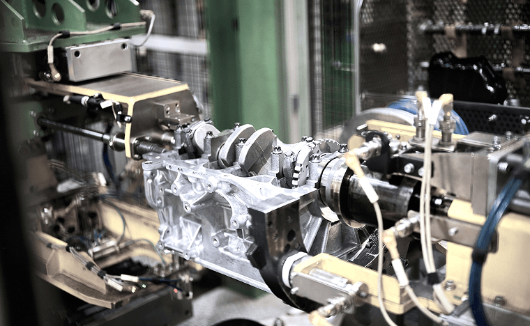 Custom automated machining fixture holding a cast aluminum housing for multi-axis precision boring and milling operations