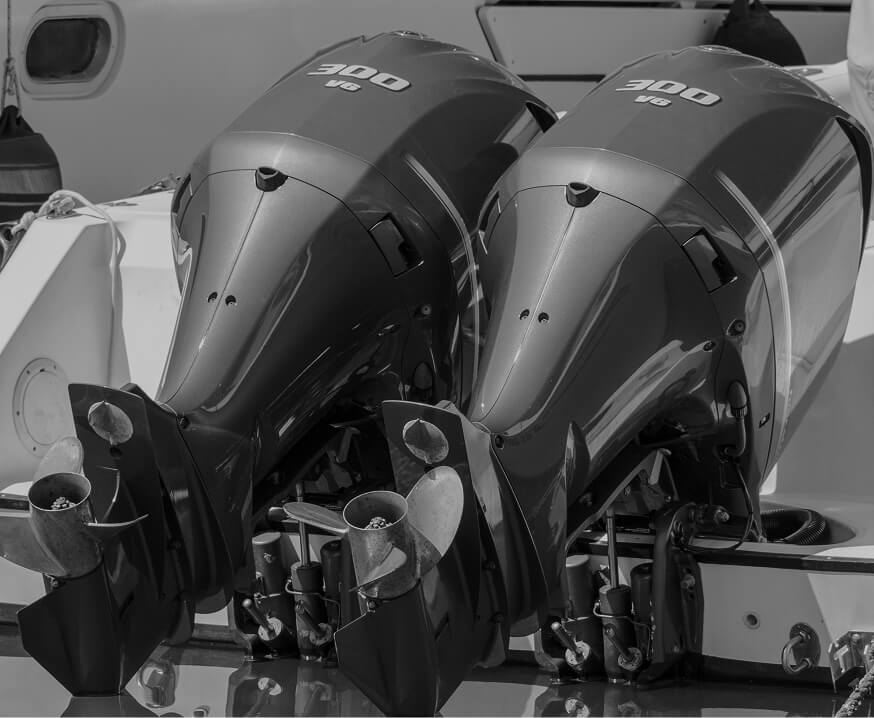 Twin 300hp V6 outboard motors mounted on a marine vessel, representing precision machined marine engine and propulsion components